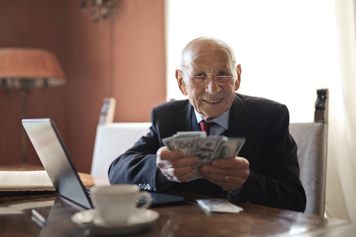 elder man holding money